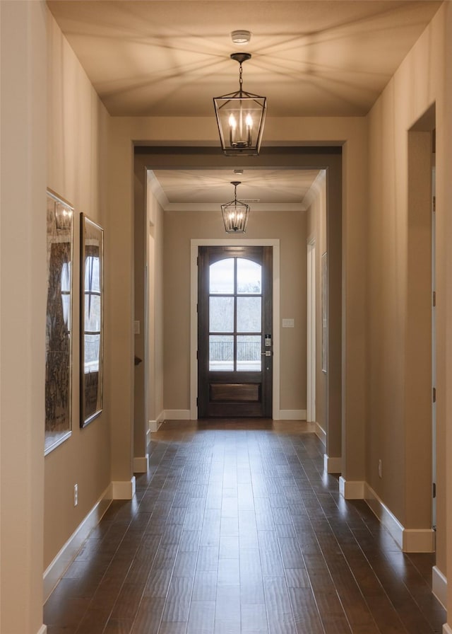 entrance foyer with dark hardwood / wood-style floors and a notable chandelier