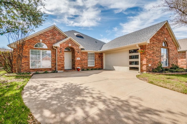 view of front of property with brick siding, an attached garage, driveway, and roof with shingles