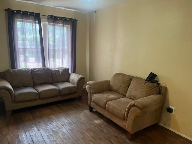 living room with dark hardwood / wood-style flooring