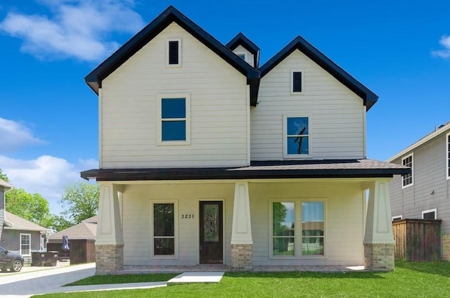 view of front of property featuring a front yard and covered porch