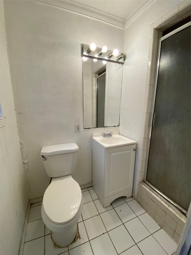 bathroom featuring crown molding, an enclosed shower, vanity, tile patterned floors, and toilet