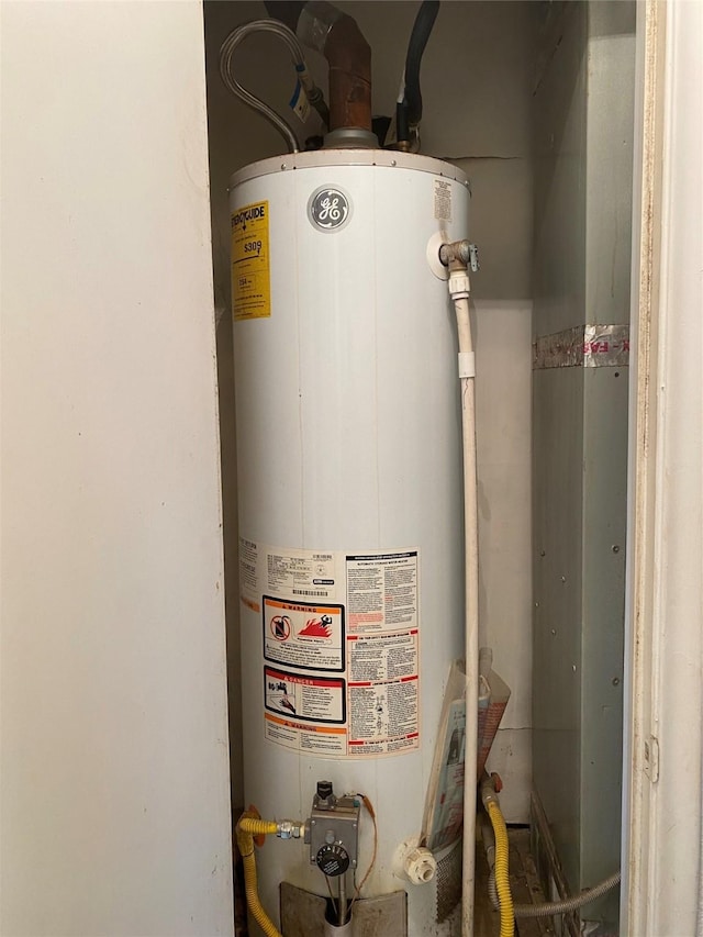 utility room with water heater