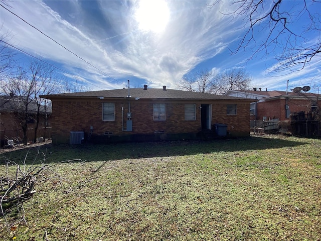 rear view of house featuring a yard and central air condition unit