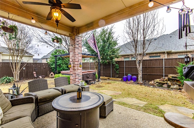 view of patio featuring ceiling fan and a hot tub