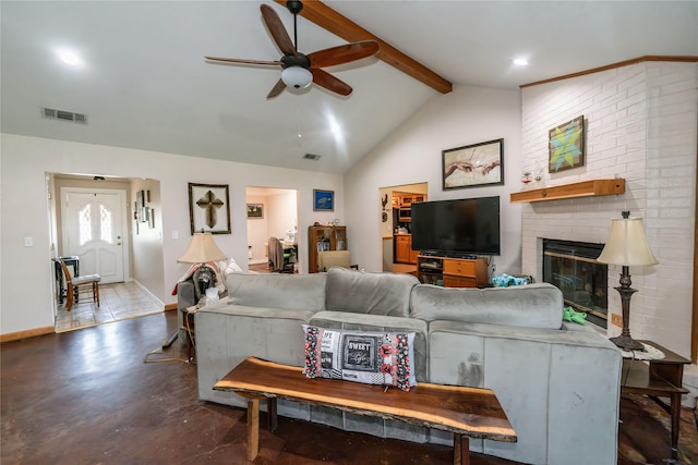 living room with ceiling fan, a fireplace, and vaulted ceiling with beams