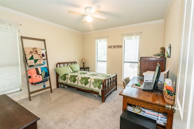 bedroom featuring ornamental molding, light colored carpet, and ceiling fan