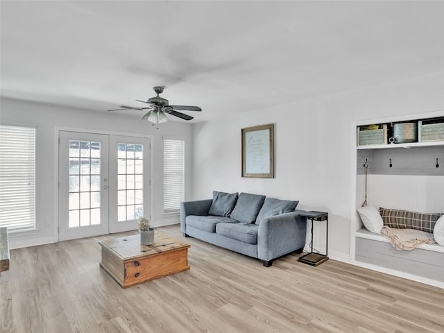 living room featuring french doors, ceiling fan, and light wood-type flooring