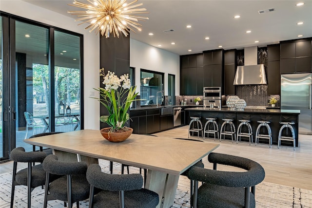 dining room with a chandelier and light hardwood / wood-style floors