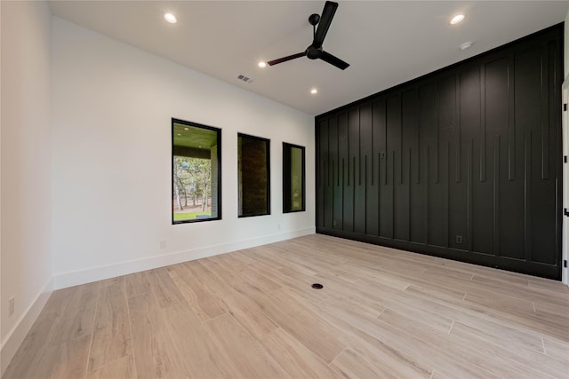 spare room featuring light hardwood / wood-style floors and ceiling fan