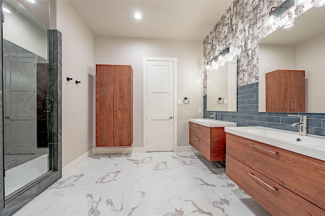 bathroom featuring a shower with door, vanity, and backsplash