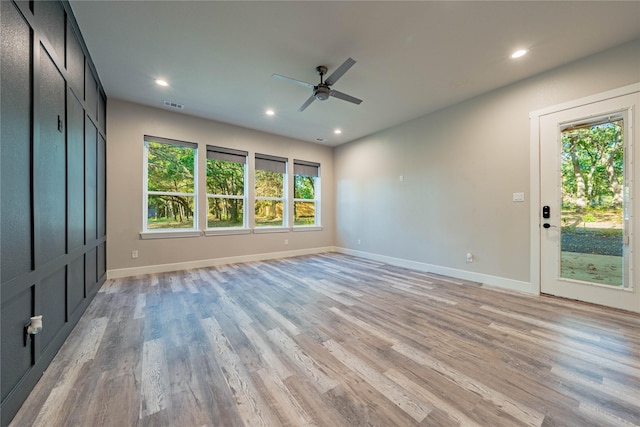 interior space with ceiling fan, access to outside, and light wood-type flooring