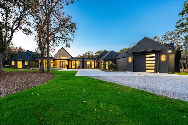 view of front of house featuring a garage and a lawn