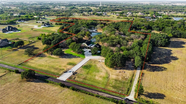 aerial view with a rural view and a water view