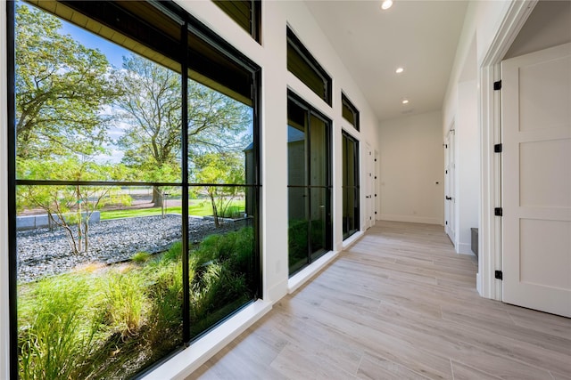 corridor with light hardwood / wood-style flooring