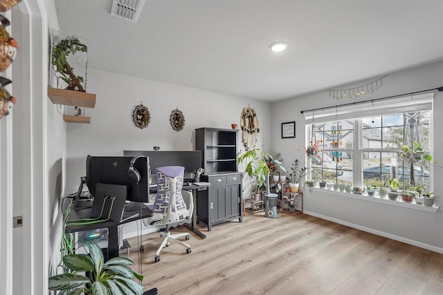 office space with light wood-type flooring