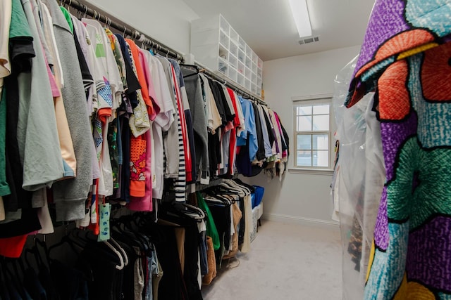 spacious closet featuring light carpet