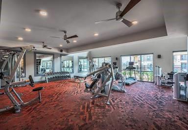 exercise room featuring ceiling fan and carpet