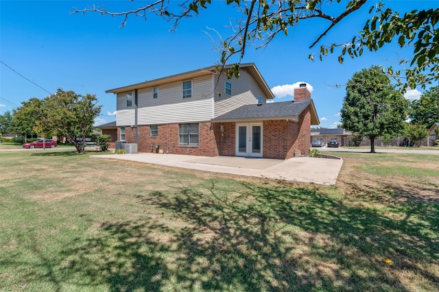 back of house featuring a patio area, french doors, and a lawn