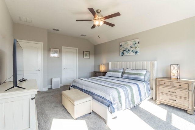 carpeted bedroom with vaulted ceiling, ceiling fan, and a closet