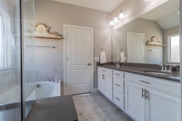 bathroom with independent shower and bath, vanity, vaulted ceiling, and tile patterned floors