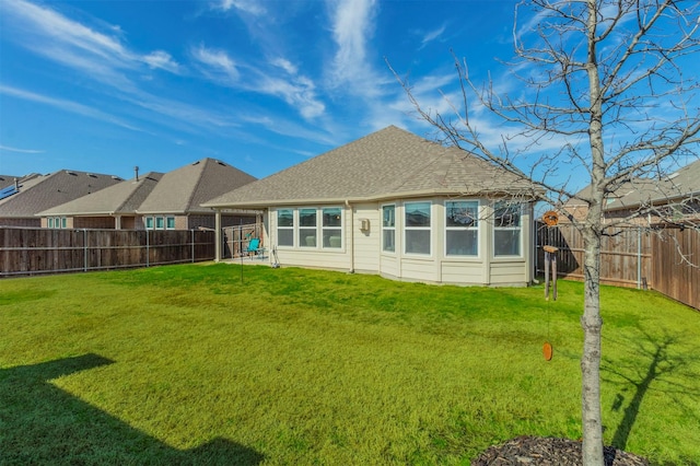 back of house featuring a yard