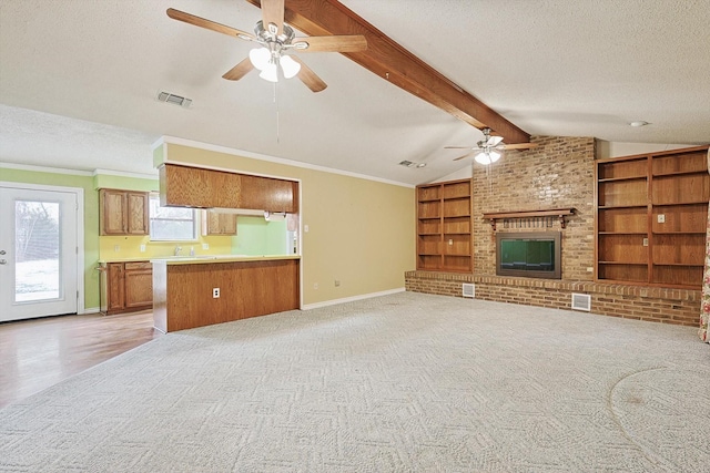 1806 Duck Creek Rd, Sanger, TX 76266 - unfurnished living room featuring visible vents, a ceiling fan, lofted ceiling with beams, a textured ceiling, and light colored carpet