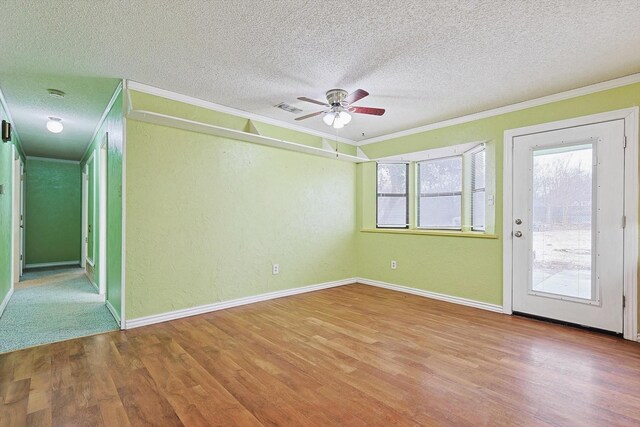 1806 Duck Creek Rd, Sanger, TX 76266 - empty room with a ceiling fan, wood finished floors, a textured ceiling, and crown molding