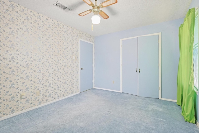 1806 Duck Creek Rd, Sanger, TX 76266 - unfurnished bedroom featuring wallpapered walls, a textured ceiling, carpet flooring, and baseboards