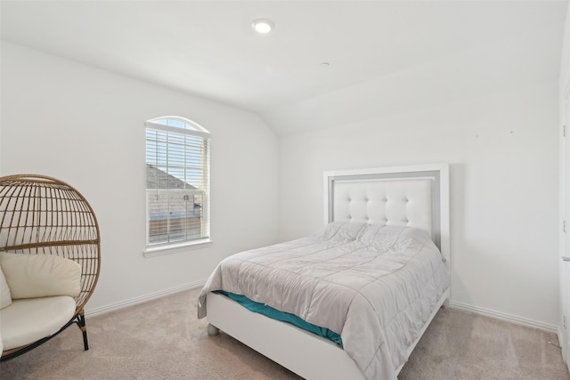 bedroom with baseboards, lofted ceiling, and carpet