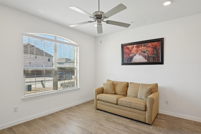 sitting room with ceiling fan, baseboards, wood finished floors, and recessed lighting