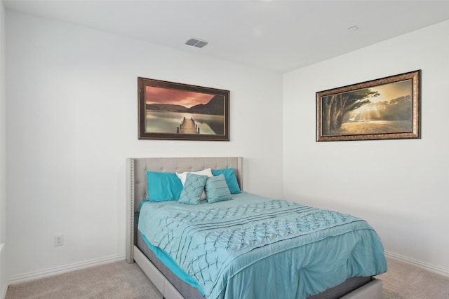 carpeted bedroom featuring baseboards and visible vents