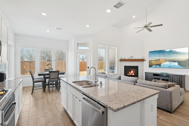 kitchen featuring white cabinets, visible vents, appliances with stainless steel finishes, and a sink