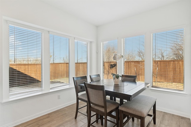 dining area featuring light wood-style floors and baseboards