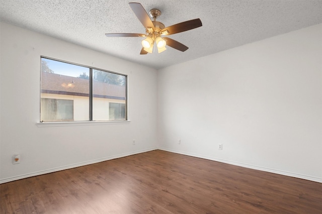 empty room featuring a textured ceiling, ceiling fan, and dark hardwood / wood-style floors