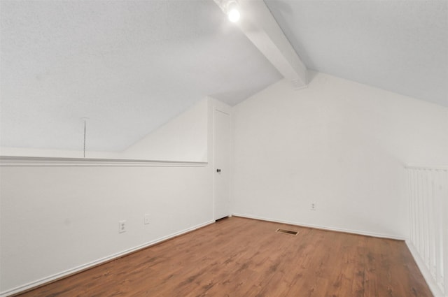 bonus room with lofted ceiling with beams and wood-type flooring