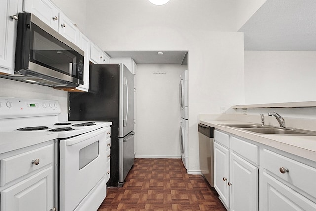 kitchen featuring sink, white cabinets, stainless steel appliances, and dark parquet floors