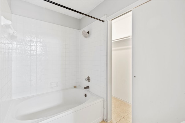 bathroom featuring tiled shower / bath combo and tile patterned flooring