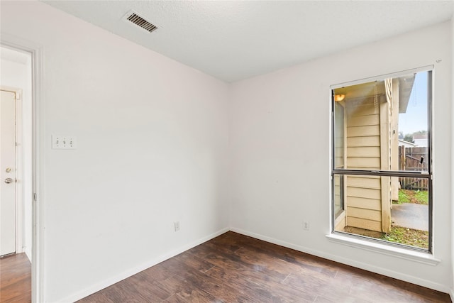 unfurnished room featuring dark hardwood / wood-style floors