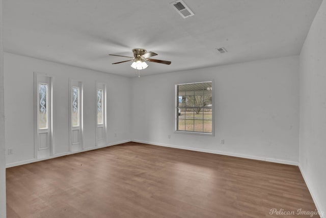 10553 White Oak Dr, Keithville, LA 71047 - empty room featuring ceiling fan, wood-type flooring, and a wealth of natural light