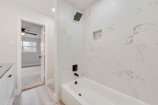 bathroom with vanity, tiled shower / bath combo, and hardwood / wood-style flooring