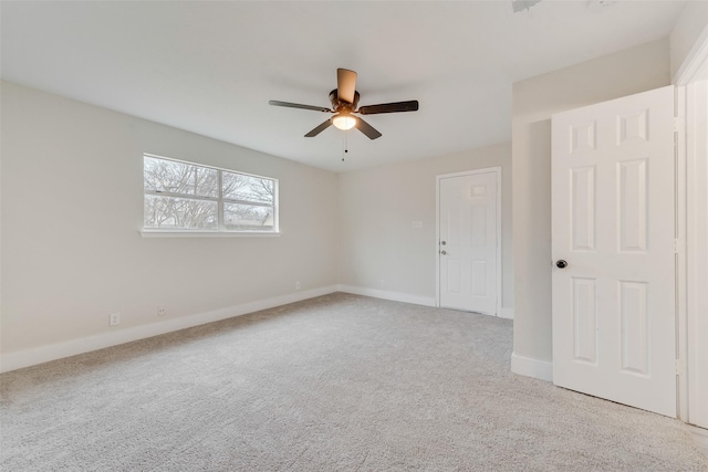 carpeted empty room featuring ceiling fan