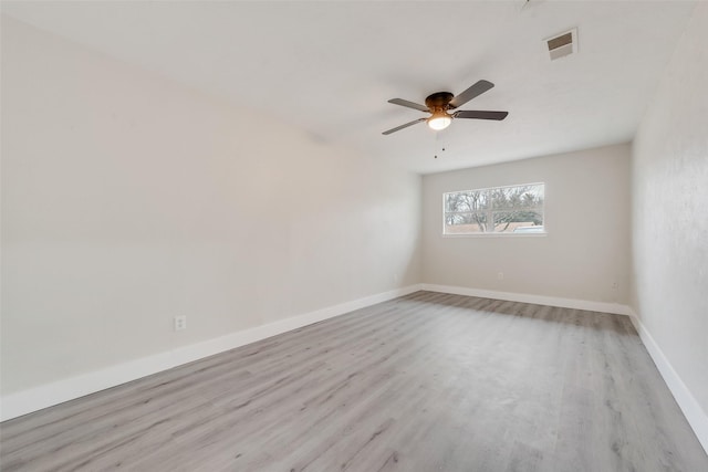 spare room featuring ceiling fan and light hardwood / wood-style floors