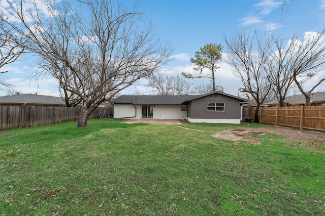 rear view of property featuring a patio and a yard