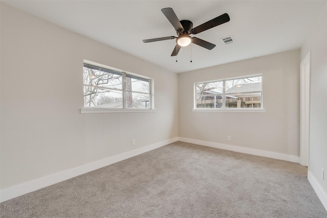 spare room featuring ceiling fan and carpet flooring