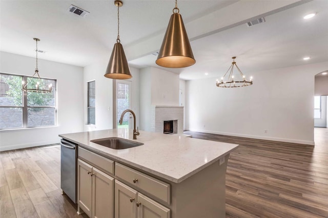 782 Sterling Dr, Benbrook, TX 76126 - kitchen featuring a sink, a chandelier, open floor plan, stainless steel dishwasher, and plenty of natural light