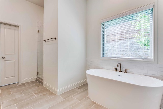 782 Sterling Dr, Benbrook, TX 76126 - full bathroom with a soaking tub, a shower stall, and baseboards