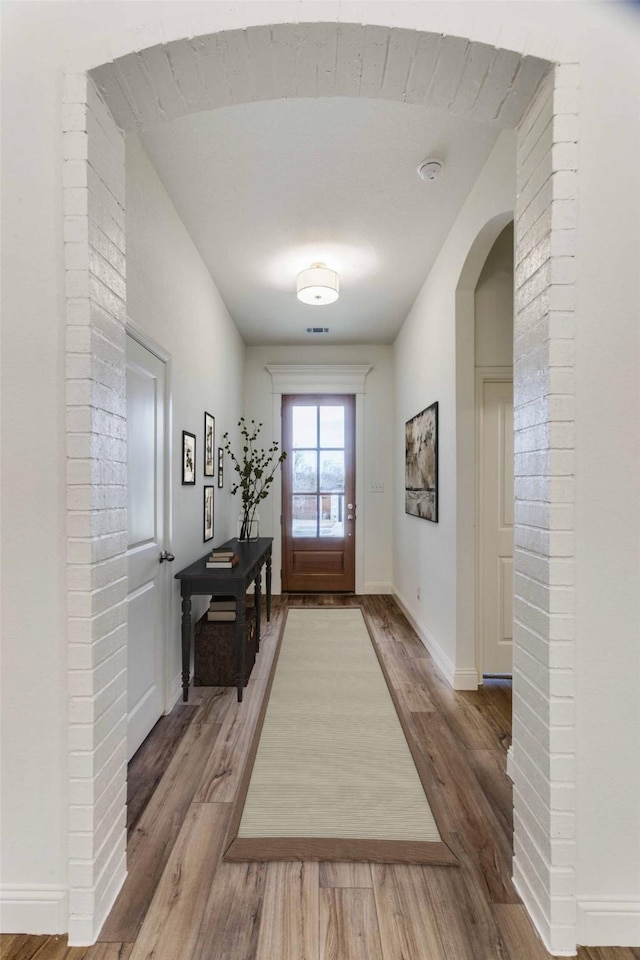 782 Sterling Dr, Benbrook, TX 76126 - doorway to outside with wood finished floors, baseboards, and arched walkways