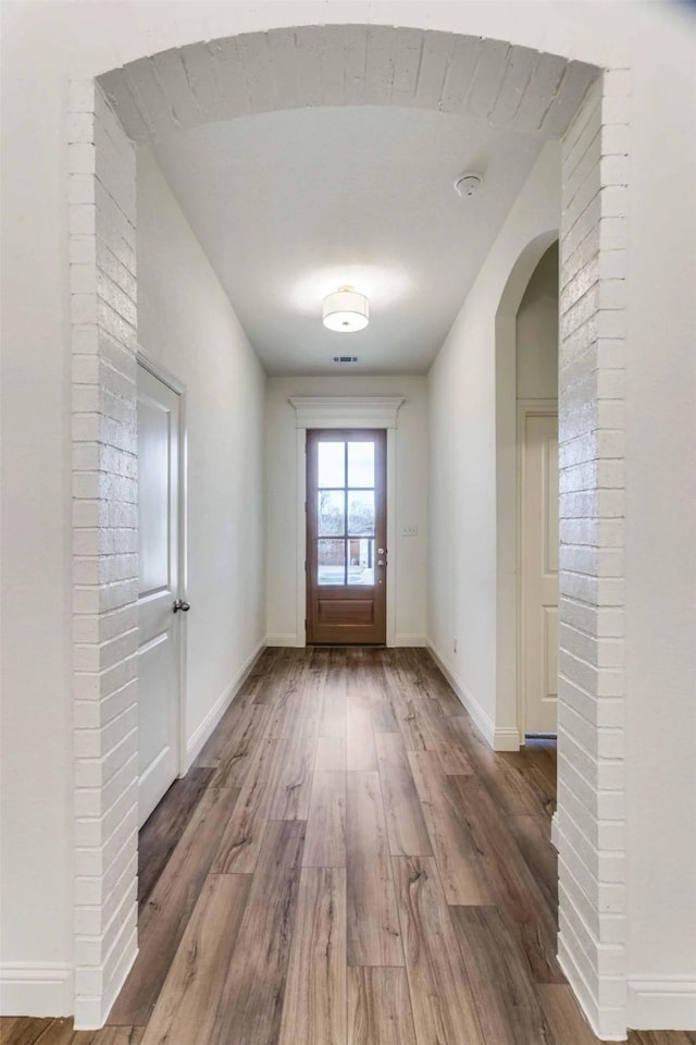 782 Sterling Dr, Benbrook, TX 76126 - doorway to outside featuring wood finished floors, baseboards, and arched walkways