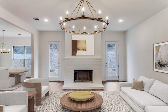 782 Sterling Dr, Benbrook, TX 76126 - living area with a chandelier, wood finished floors, a fireplace, and recessed lighting
