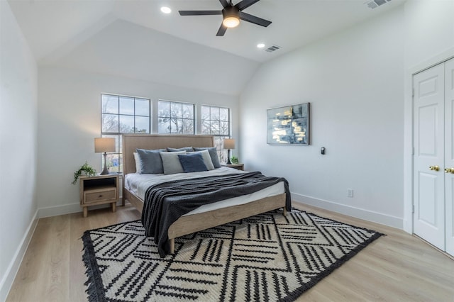 bedroom with ceiling fan, lofted ceiling, and light wood-type flooring